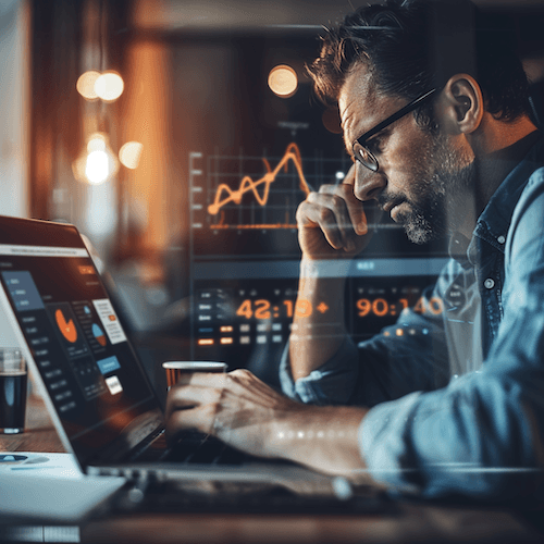 Man analyzing data on laptop at night